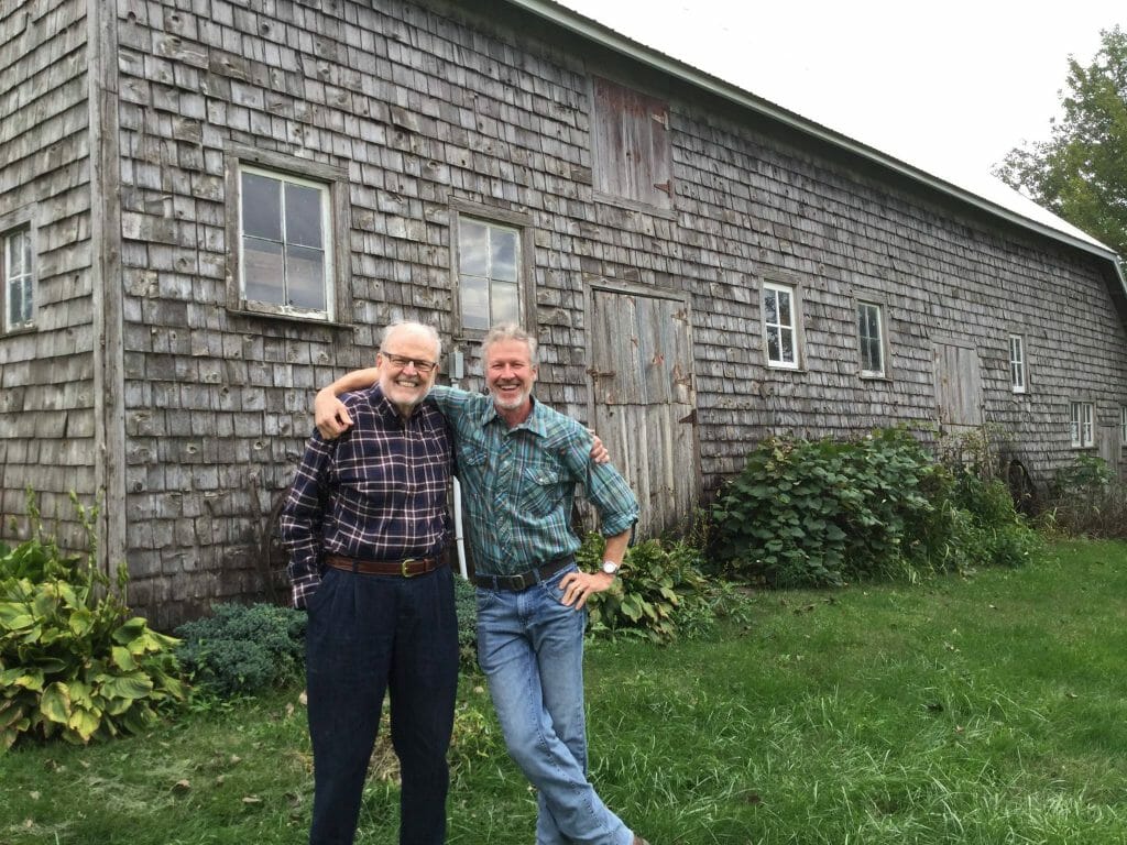 Clark Porter with his father in front of his great-great grandfather's barn. Clark's sons will be the sixth generation to be involved with their farm.