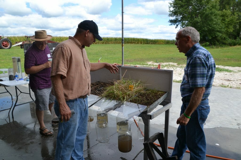 Tom Wind (right) discusses the rainfall simulator results with Doug Peterson.