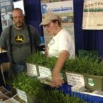 Sarah Carlson discussing cover crops at PFI Farm Progress Show booth 545x727