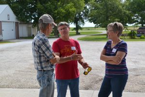 Kelly Blair, A.J.'s father, speaks with PFI members Larry and Ruth Neppl. The Neppls have been PFI members since 1988, knew A.J. as a boy and are renting some land to Kellie and A.J.