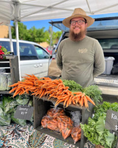Ethan at market with carrots