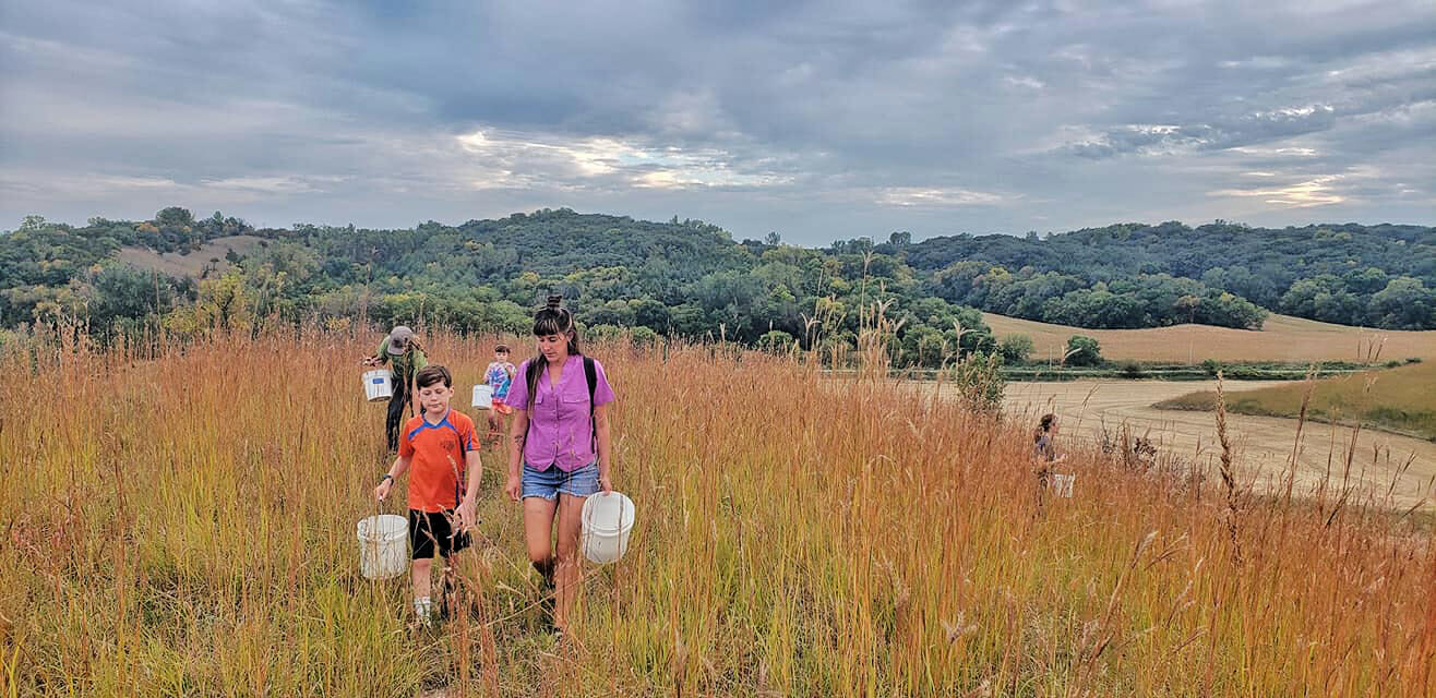 Cait Caughey and family collect native seeds in Loess Hills.