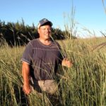 Kevin Fulton standing in tall prairie grass. 