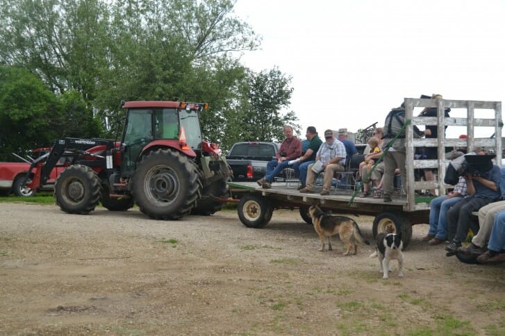 Attendees at Fred Abels' field day get a hay wagon ride out to the fields.