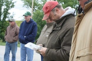 PFI member Steve McGrew tries to identify all 12 different seeds of species Mark planted in his cover crop mix.
