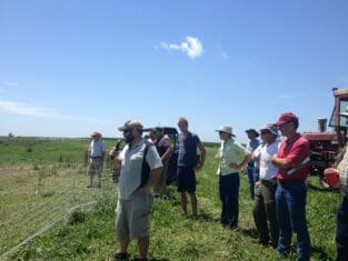 Justin Wade shows field day attendees his pastured poultry hoopie