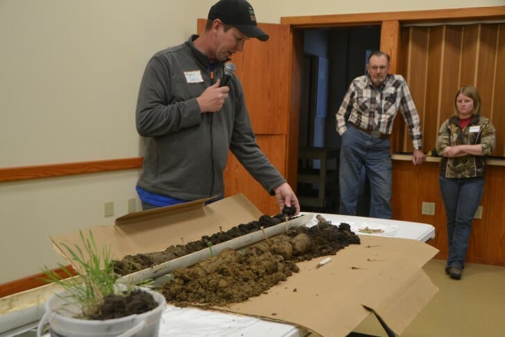 Neil Sass, NRCS, describes some of the soil they brought in from Jacks field. The golf tees in the soil cores indicate where Neil observed earthworm channels.