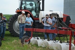 Craig explains how he bands herbicide and uses hood to prevent drift.