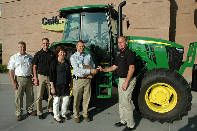 As Conservation Farmer of the Year, the VanWall Group of Perry presented Chris Teachout with keys to a John Deere tractor for 12 months or 200 hours.